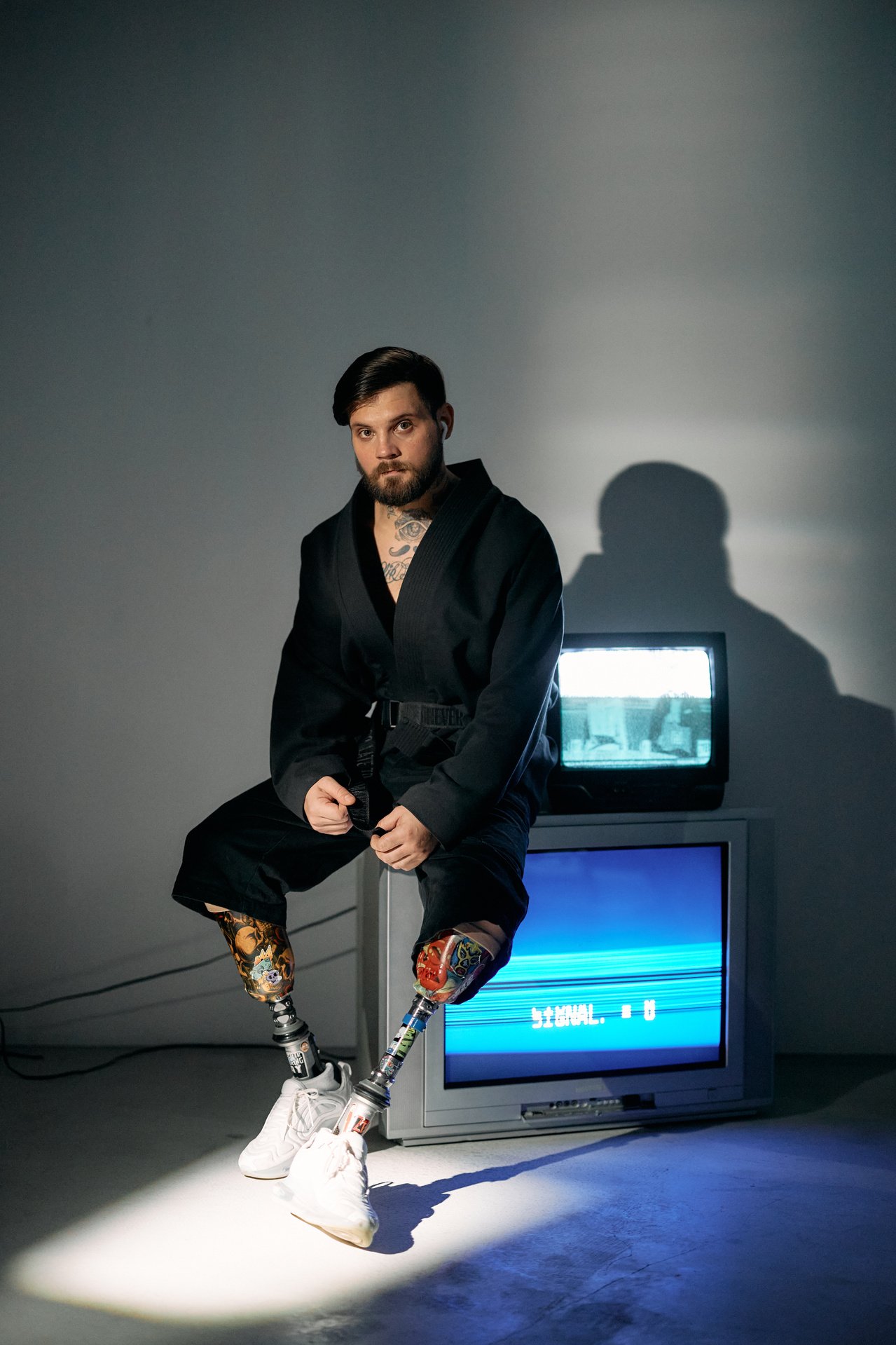 Photo of Man Sitting on Top of Television