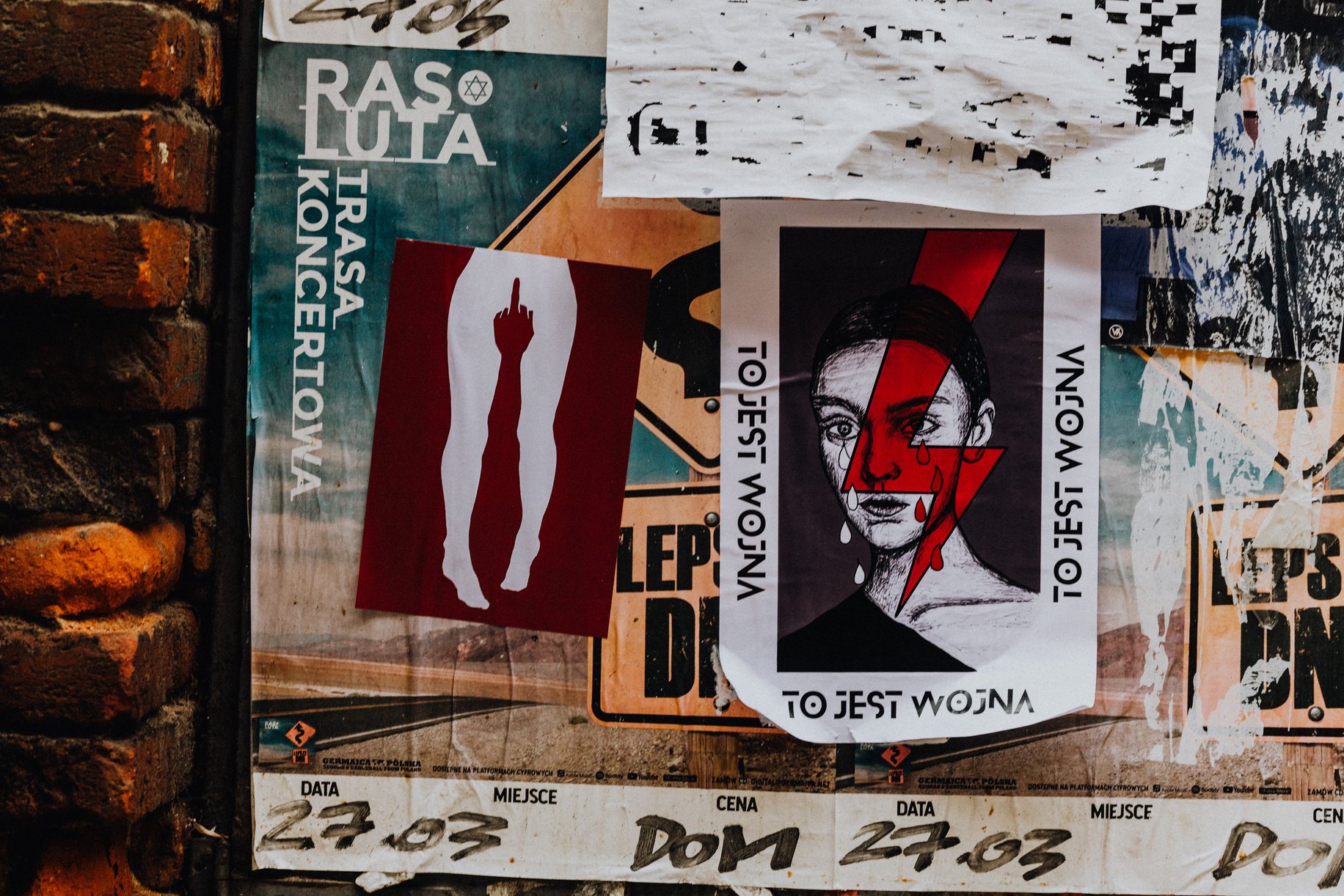 Leaflets and Posters Attached to a Wall in City 